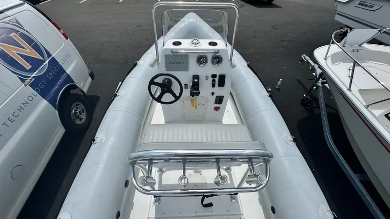 Slide: The Image of 2022 Ribcraft 5.85 boat interior with steering console and seating. - 3