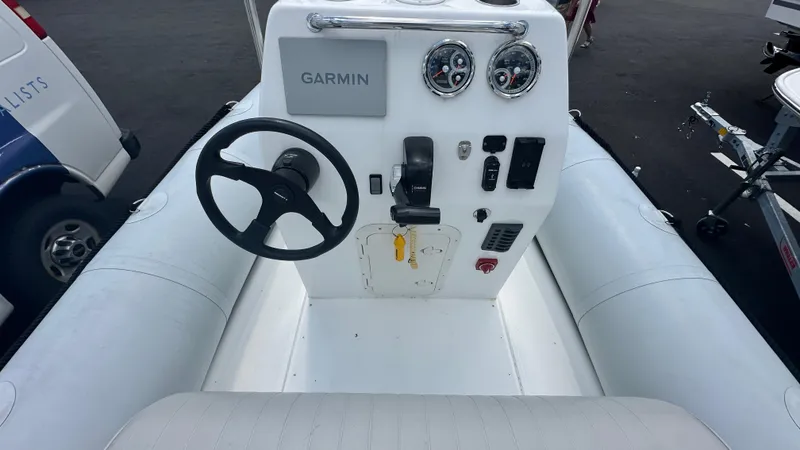 Slide: The Image of 2022 Ribcraft 5.85 boat console with Garmin navigation and steering wheel. - 4