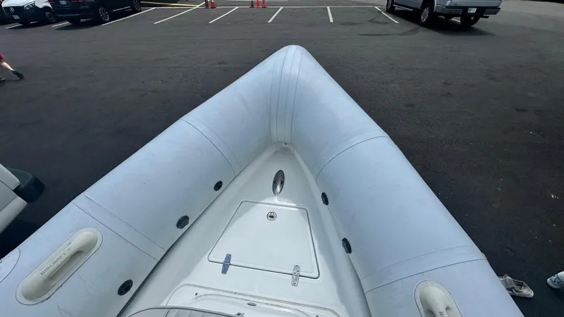 Slide: The Image of Ribcraft 5.85 inflatable boat, 2022 model, parked on asphalt surface. - 5