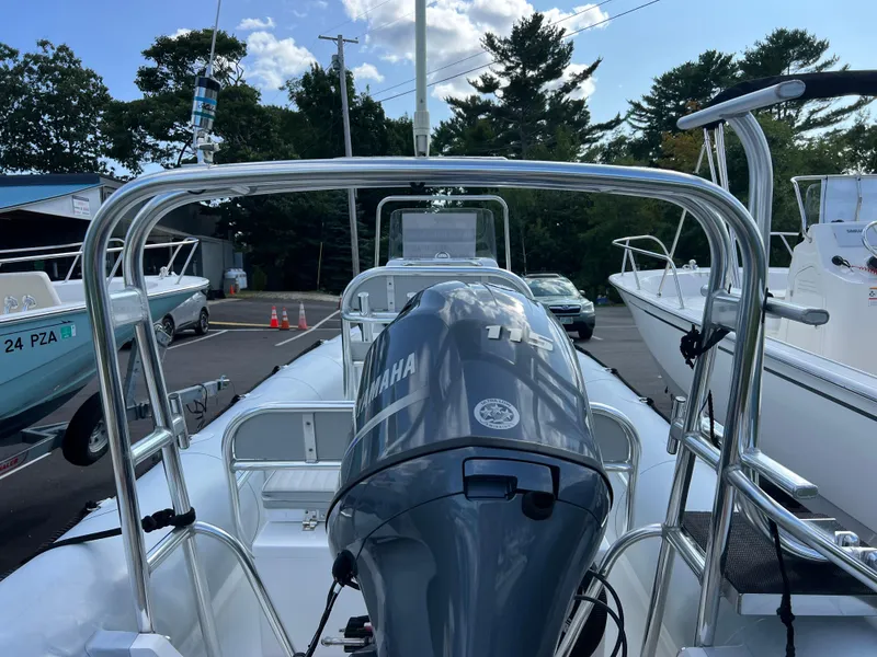 Slide: The Image of 2022 Ribcraft 5.85 boat with Yamaha engine, docked in a marina. - 7