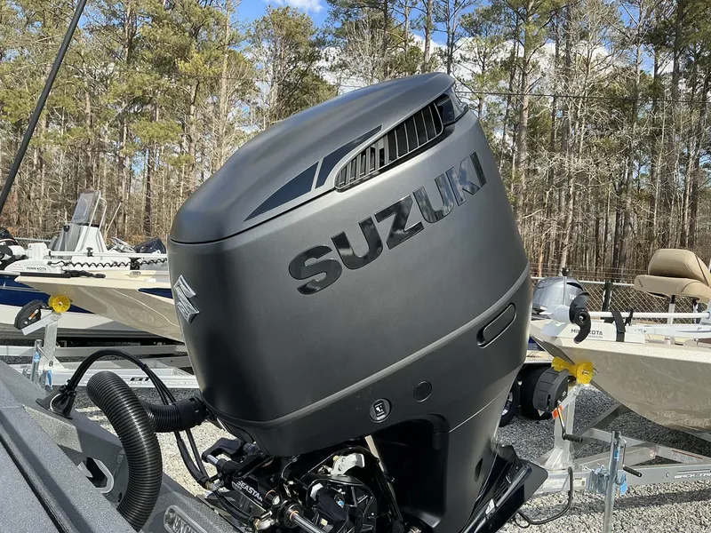 Slide: The Image of Suzuki outboard motor on Excel New Bay Pro 230 SEADECK, 2025 model, in a wooded area. - 4