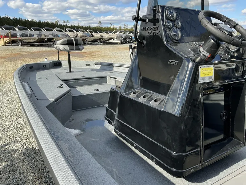 Slide: The Image of 2025 Excel New Bay Pro 230 SEADECK boat, sleek design, outdoor display. - 6