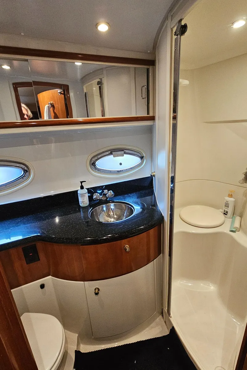 Slide: The Image of Luxurious bathroom in 2002 Carver 396 Motor Yacht with modern fixtures and elegant design. - 16