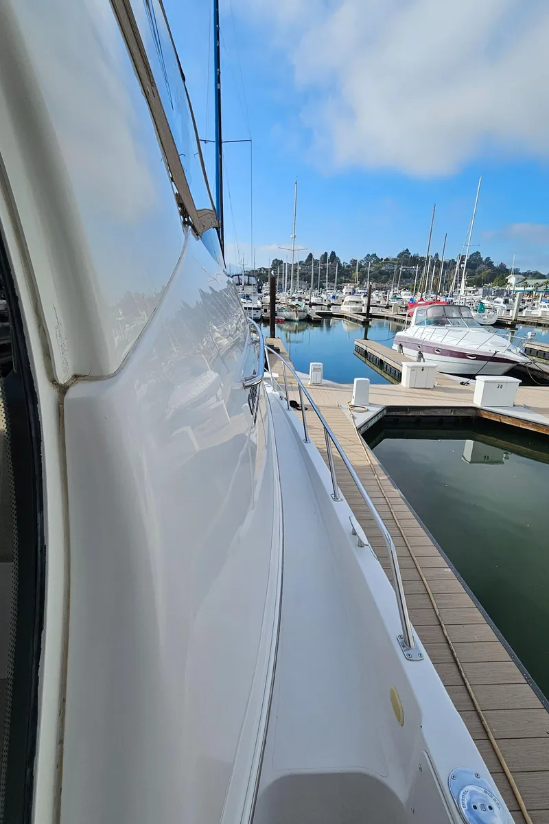 Slide: The Image of 2002 Carver 396 Motor Yacht docked at marina under blue sky. - 17