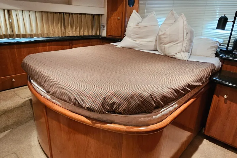 Slide: The Image of Luxurious bedroom interior of 2002 Carver 396 Motor Yacht with cozy bedding and elegant wood finish. - 14