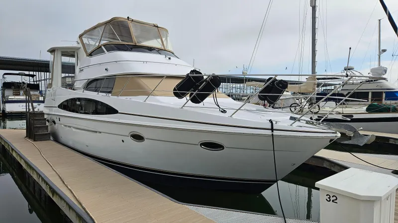 Slide: The Image of 2002 Carver 396 Motor Yacht docked at marina, featuring sleek design and spacious cabin. - 21