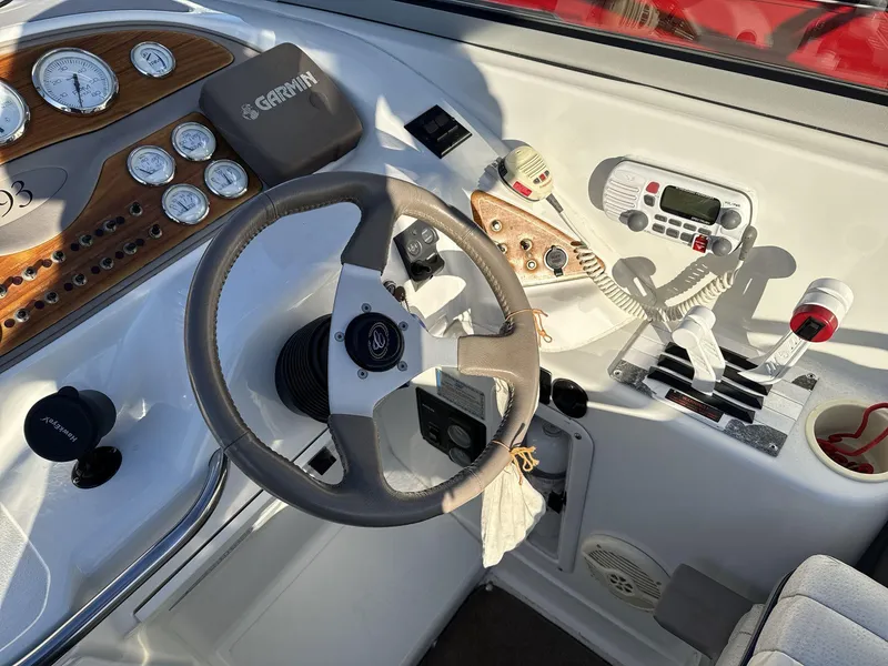 Slide: The Image of Steering console of a 2000 Cobalt 293 boat with gauges and controls. - 10