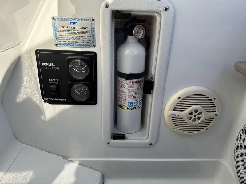 Slide: The Image of Control panel and fire extinguisher on a 2000 Cobalt 293 boat, featuring Kohler generator controls. - 12