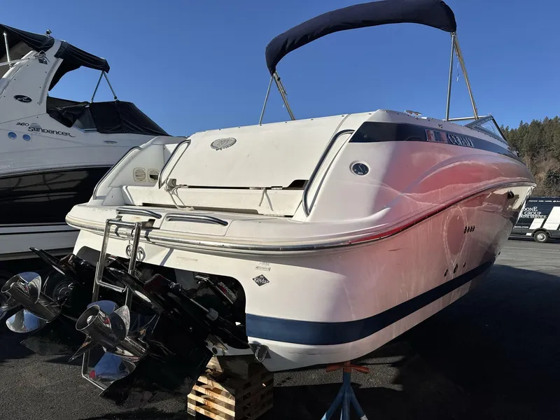 Slide: The Image of 2000 Cobalt 293 boat with dual propellers, docked outdoors under clear blue sky. - 4