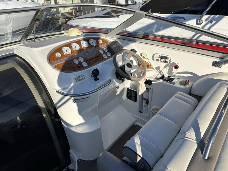 Slide: The Image of Cockpit of a 2000 Cobalt 293 boat with steering wheel and control panel. - 9