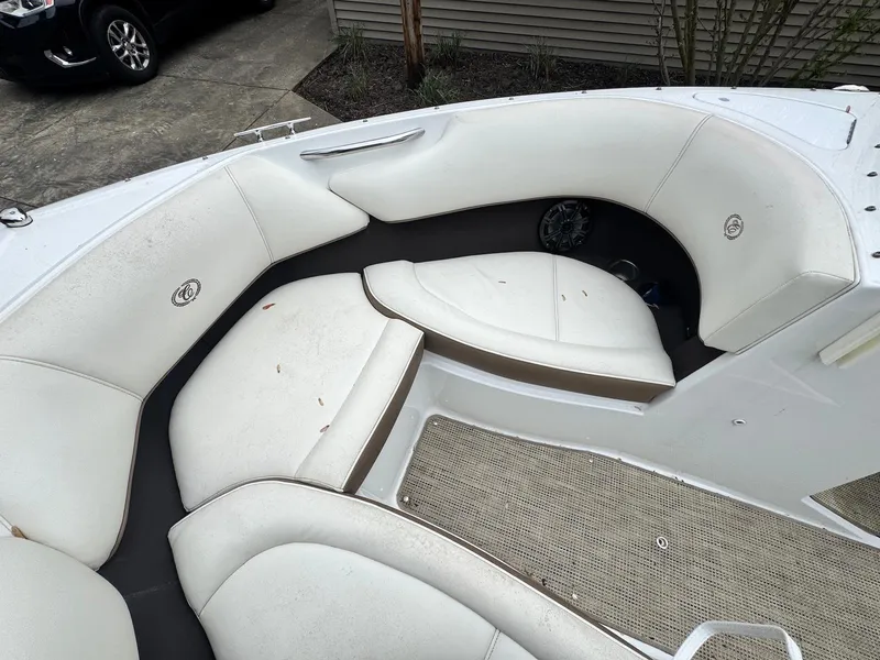 Slide: The Image of 2016 Cobalt 200S boat interior with white cushioned seating and carpeted flooring. - 11