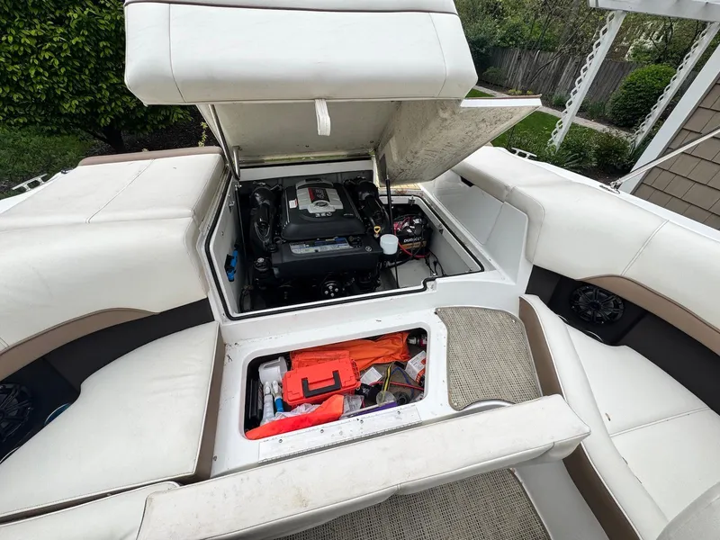 Slide: The Image of 2016 Cobalt 200S boat engine compartment with open hatch, revealing storage and engine details. - 14