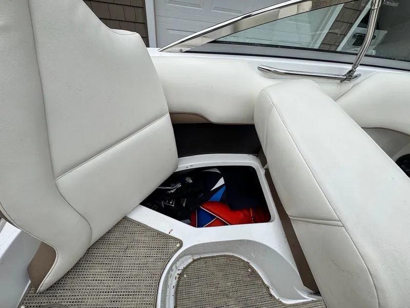 Slide: The Image of 2016 Cobalt 200S boat interior with white seats and storage compartment. - 16