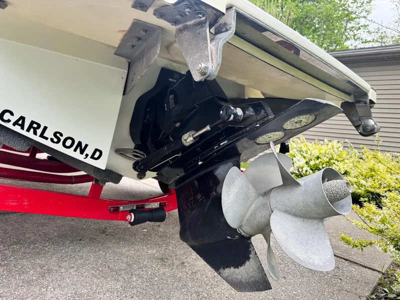 Slide: The Image of 2016 Cobalt 200S boat propeller and stern detail, parked on driveway. - 20