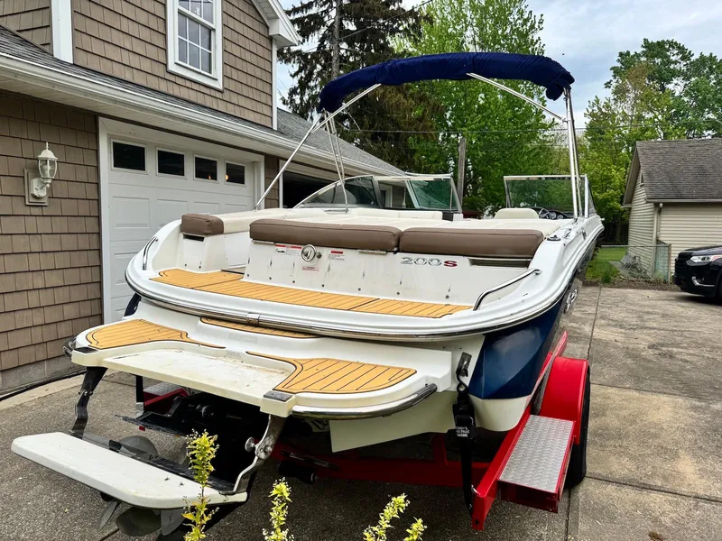 Slide: The Image of 2016 Cobalt 200S boat on trailer in driveway, featuring swim platform and canopy. - 4