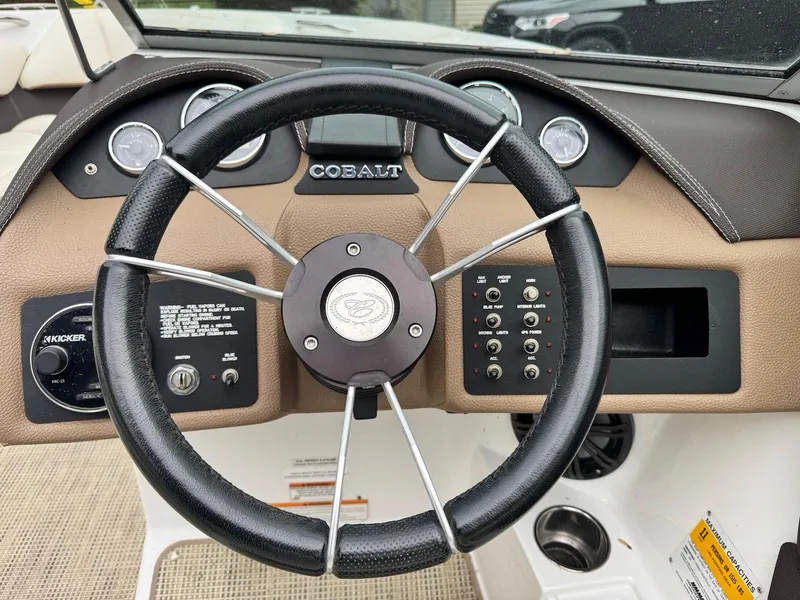 Slide: The Image of Steering wheel of a 2016 Cobalt 200S boat with dashboard controls. - 9