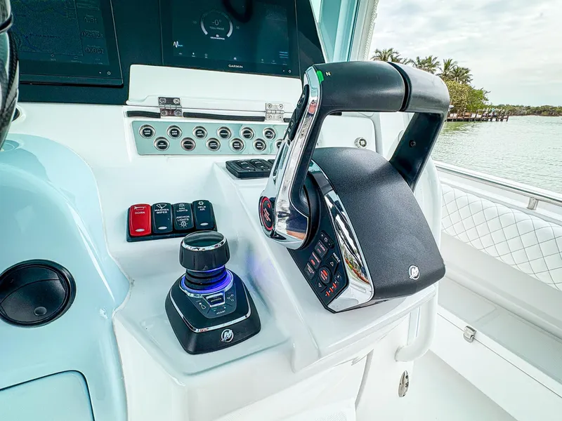 Slide: The Image of Control panel of 2023 HCB 42 Lujo boat with throttle and joystick. - 16