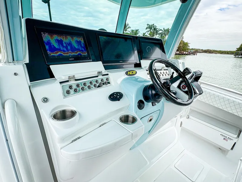 Slide: The Image of 2023 HCB 42 Lujo boat dashboard with modern controls and navigation screens. - 17