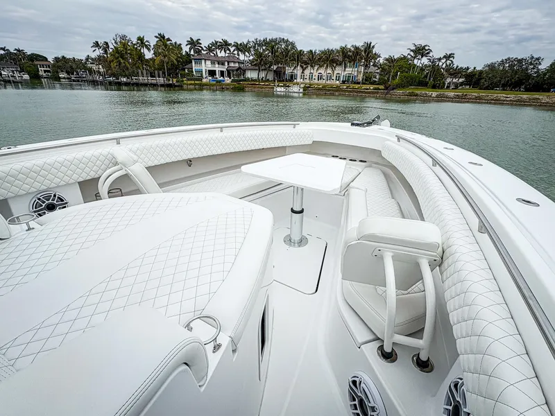 Slide: The Image of 2023 HCB 42 Lujo boat with luxurious seating and table on calm water. - 22