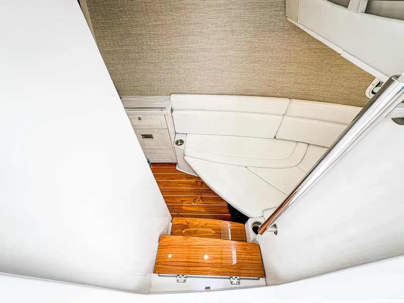 Slide: The Image of Interior of 2023 HCB 42 Lujo boat with wooden steps and white seating. - 26