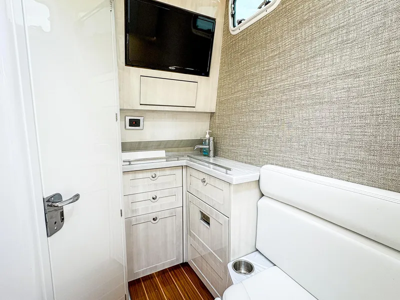 Slide: The Image of Interior of 2023 HCB 42 Lujo boat with modern cabinetry and seating. - 28