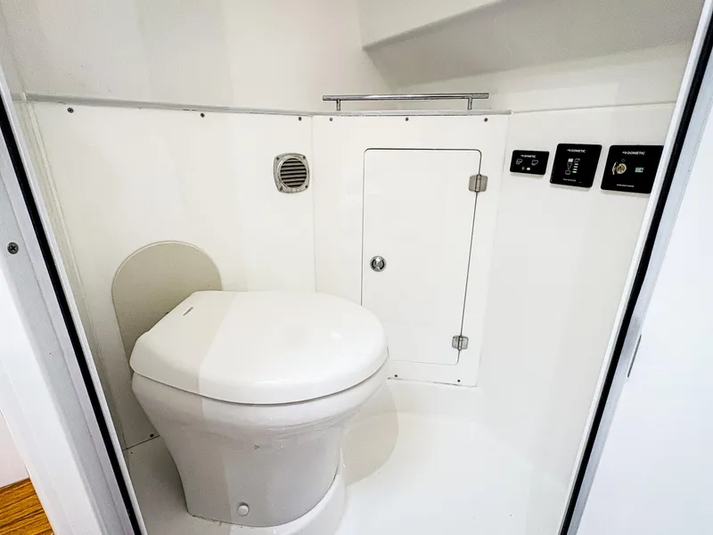 Slide: The Image of 2023 HCB 42 Lujo boat bathroom with modern toilet and control panels. - 30