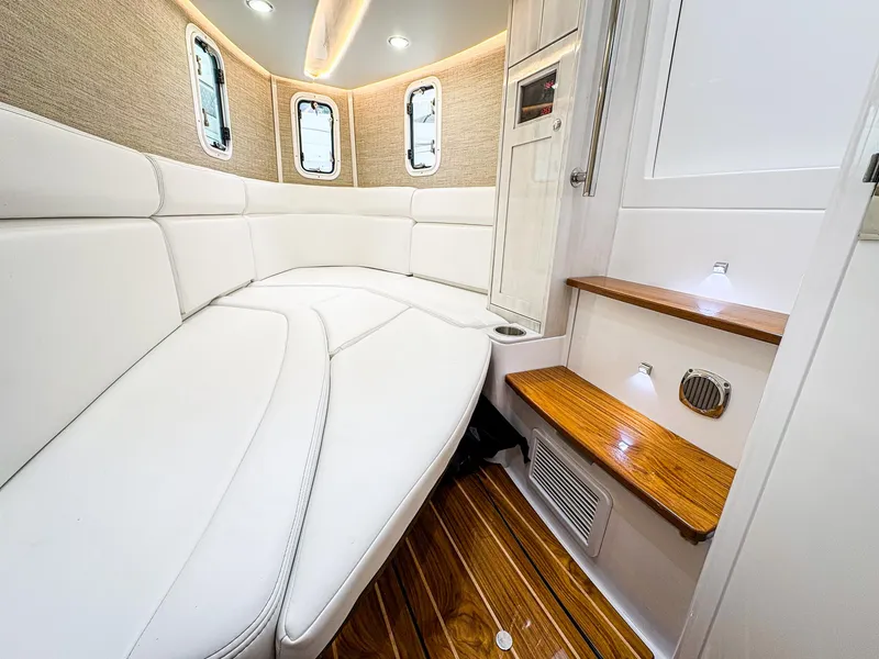 Slide: The Image of 2023 HCB 42 Lujo interior with white seating and wooden flooring. - 31