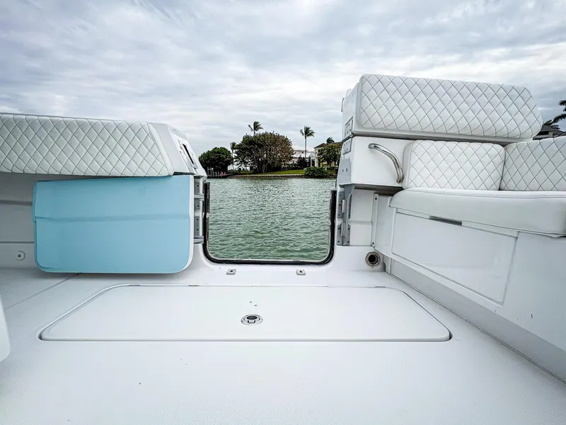 Slide: The Image of 2023 HCB 42 Lujo boat interior with quilted seating, overlooking calm water. - 33