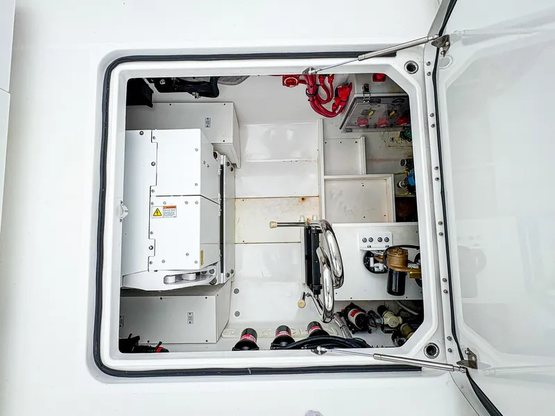 Slide: The Image of 2023 HCB 42 Lujo engine compartment with mechanical components and wiring. - 34
