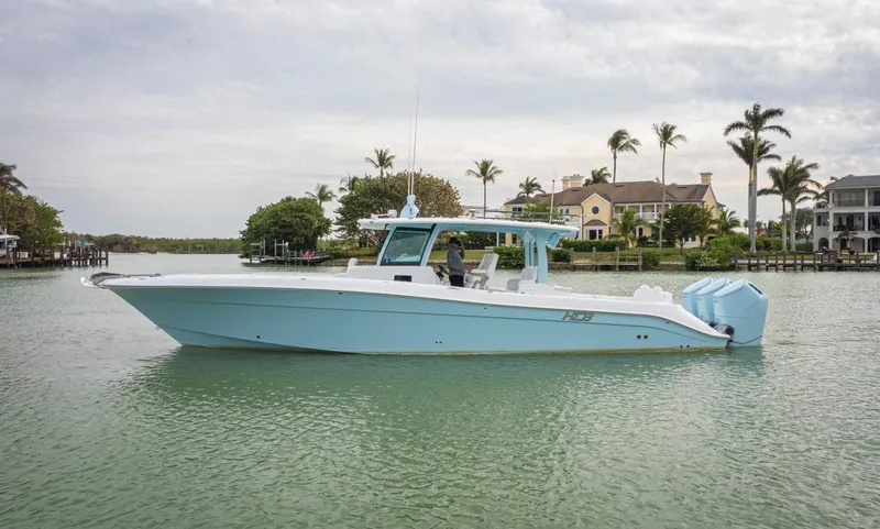 Slide: The Image of 2023 HCB 42 Lujo boat on calm water with palm trees in the background. - 37