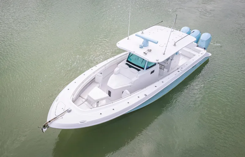 Slide: The Image of 2023 HCB 42 Lujo boat on calm water, showcasing sleek design and triple engines. - 40
