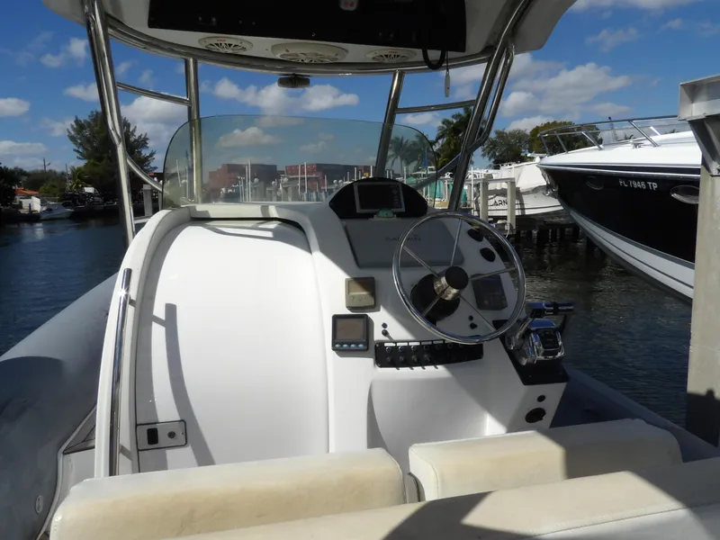 Slide: The Image of Cockpit of 2004 SACS 42 boat with steering wheel and controls, docked at marina. - 23