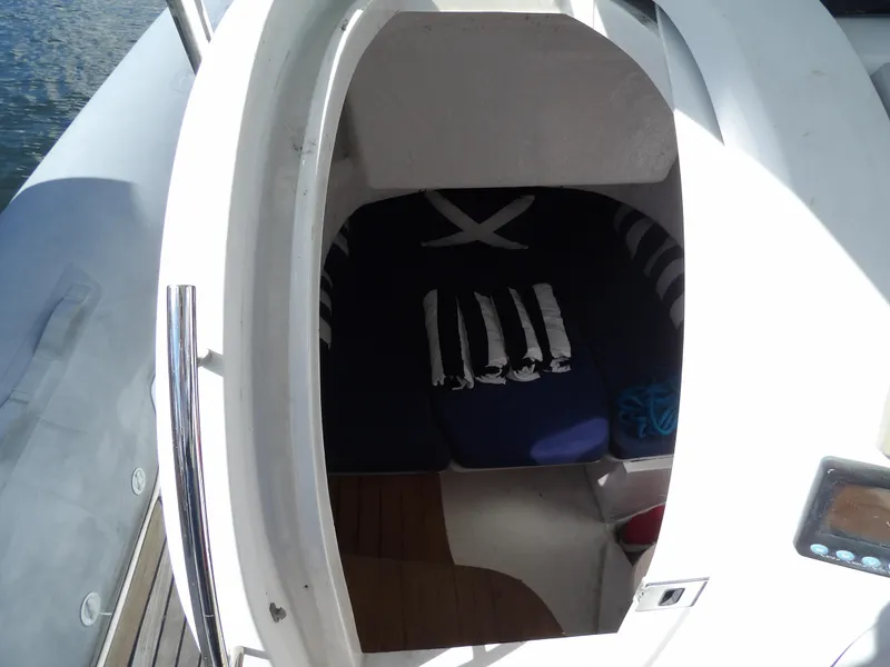 Slide: The Image of 2004 SACS 42 boat cabin interior with nautical-themed bedding. - 33
