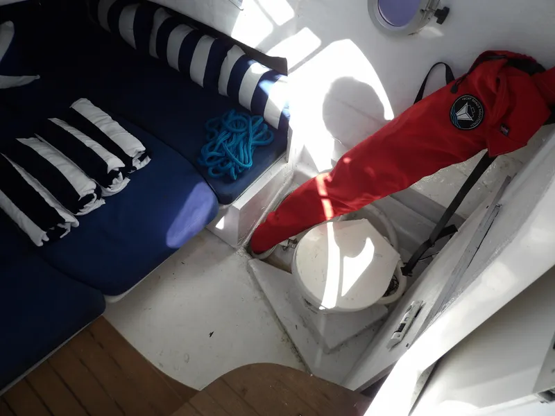 Slide: The Image of Interior of 2004 SACS 42 boat with blue seating, striped pillows, and nautical decor. - 35