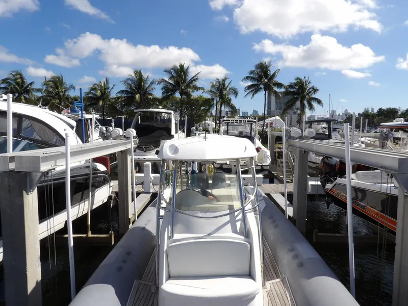 Slide: The Image of 2004 SACS 42 boat docked at marina with palm trees and blue sky. - 40