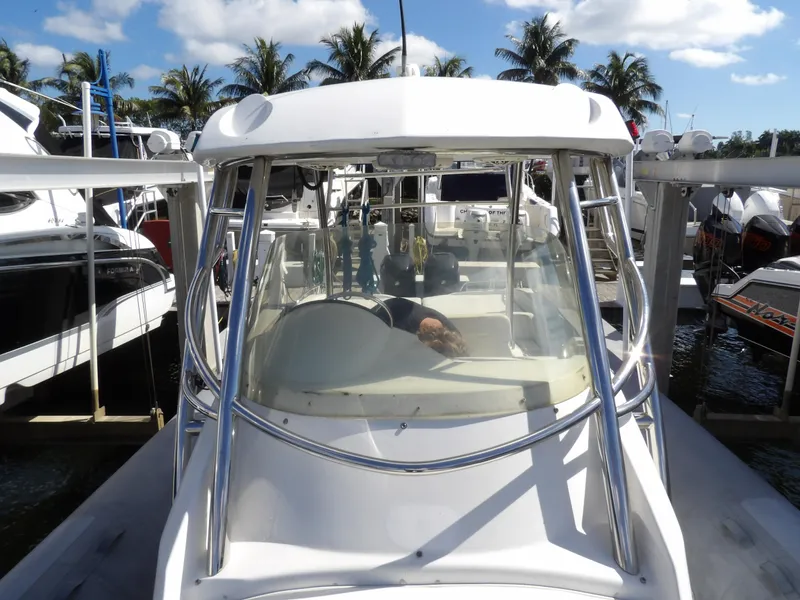 Slide: The Image of 2004 SACS 42 boat docked at marina with palm trees in background. - 41