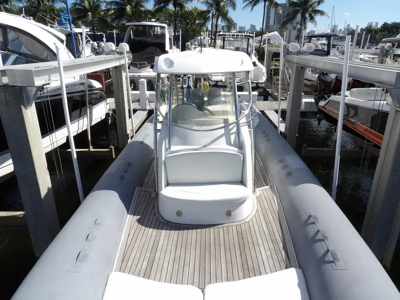 Slide: The Image of 2004 SACS 42 boat docked at marina with palm trees in background. - 42