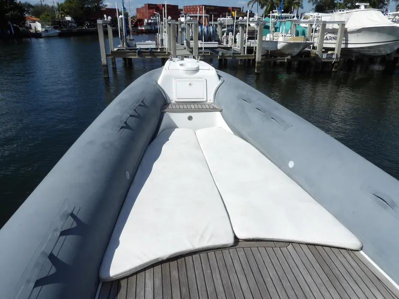Slide: The Image of 2004 SACS 42 boat with spacious deck and white seating, docked at a marina. - 45