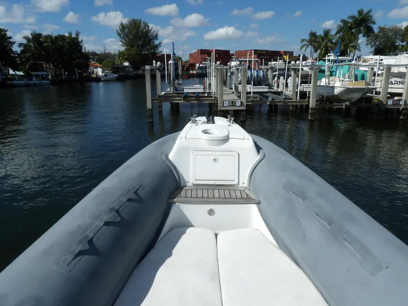 Slide: The Image of 2004 SACS 42 boat docked in a marina, featuring a spacious deck and calm waters. - 46