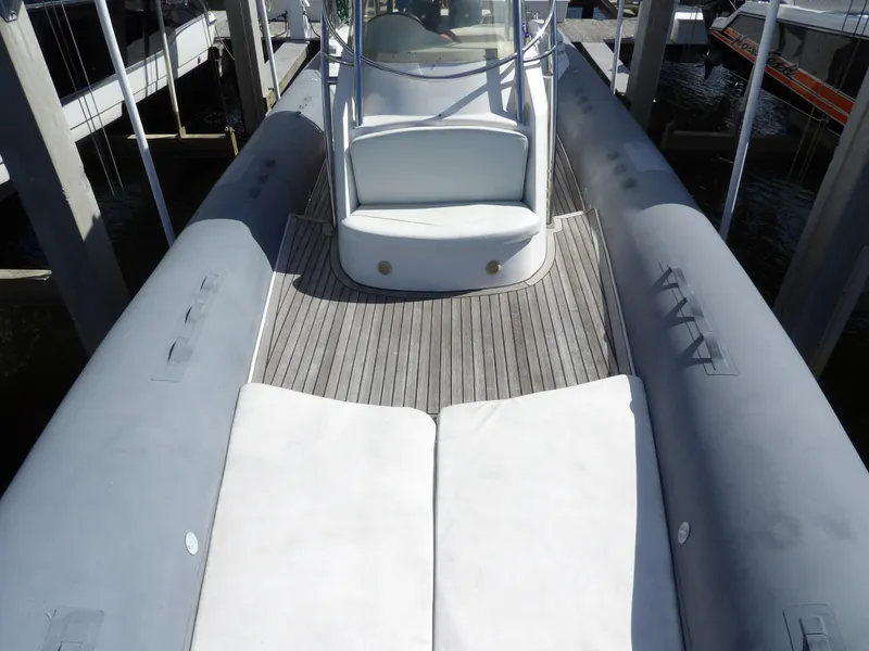 Slide: The Image of 2004 SACS 42 boat with spacious deck and cushioned seating. - 49