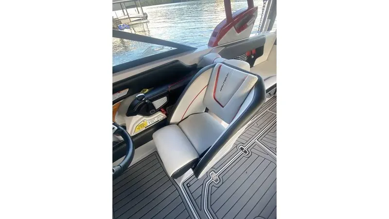 Slide: The Image of 2014 Nautique Super Air Nautique G23 interior seat with sleek design and lake view. - 10