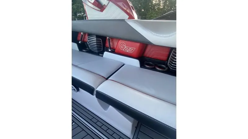 Slide: The Image of 2014 Nautique Super Air Nautique G23 interior with red and gray seating. - 13