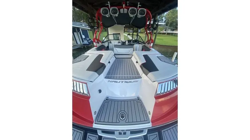 Slide: The Image of 2014 Nautique Super Air Nautique G23 boat interior with speakers and seating. - 5