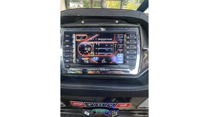 Slide: The Image of 2014 Nautique Super Air Nautique G23 dashboard display with control buttons and screen interface. - 8