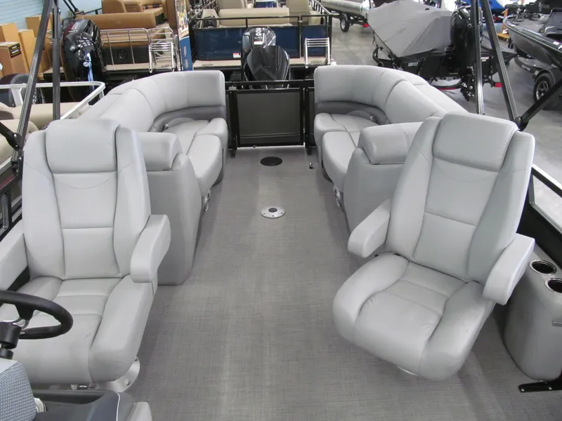 Slide: The Image of 2025 Regency 230 DL3 pontoon boat interior with gray seating and spacious layout. - 5