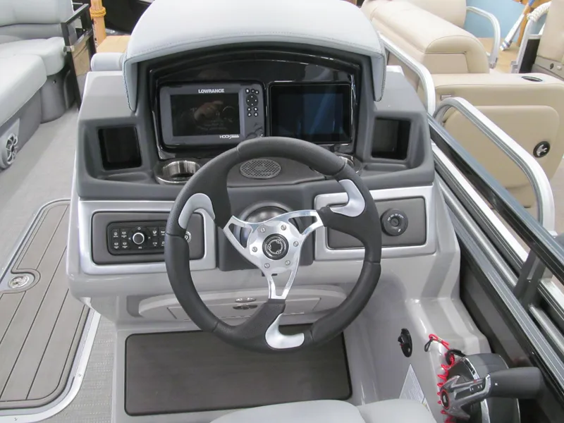 Slide: The Image of 2025 Regency 230 DL3 boat dashboard with steering wheel and navigation system. - 7