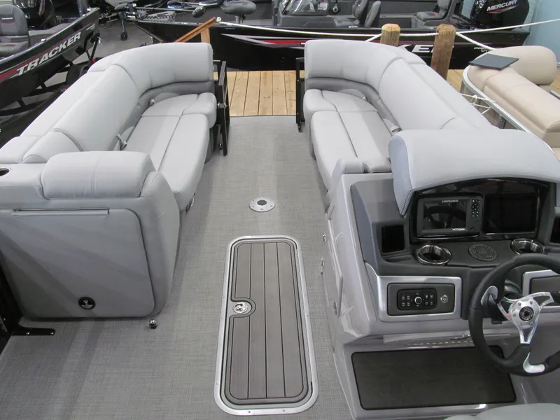Slide: The Image of 2025 Regency 230 DL3 pontoon boat interior with plush seating and modern dashboard. - 8