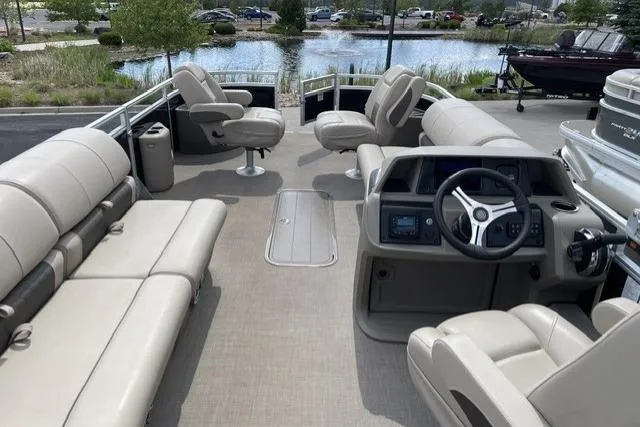Slide: The Image of 2025 Sun Tracker Sportfish 24 XP3 pontoon boat interior with plush seating and modern helm. - 2