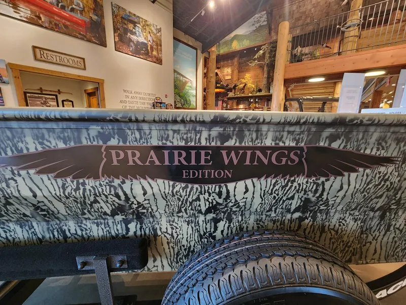 Slide: The Image of 2025 Tracker Grizzly 1650 T Prairie Wings Edition boat in showroom setting. - 4