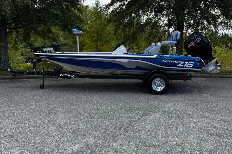 Slide: The Image of 2025 Nitro Z18 Pro fishing boat on trailer, parked outdoors. - 2